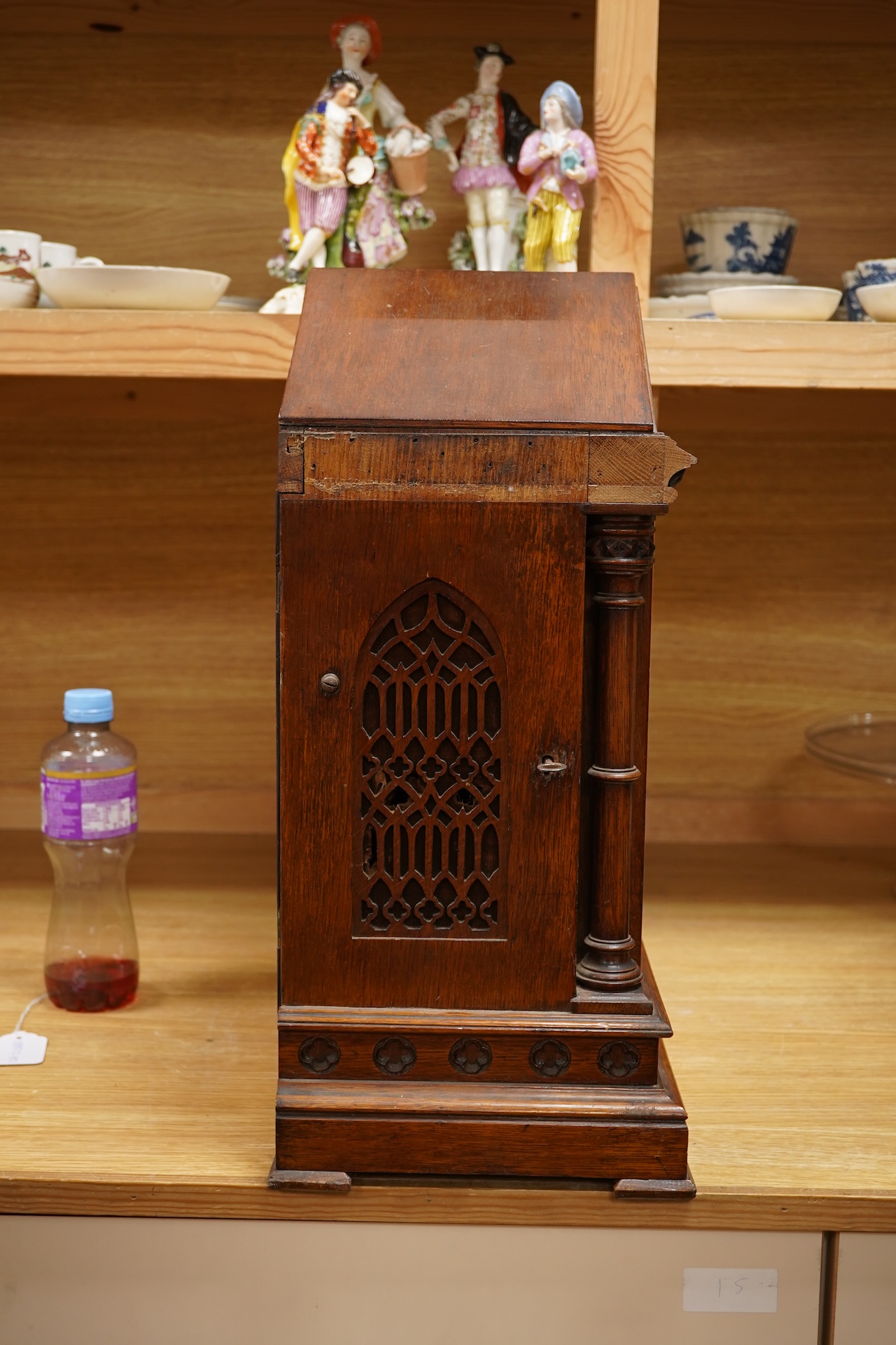 A German Gothic style oak mantel clock, early 20th century, with pendulum and keys, 49cm high